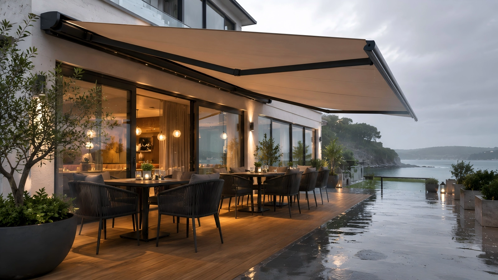 Retractable awning over patio seating for sun shade and light rain protection